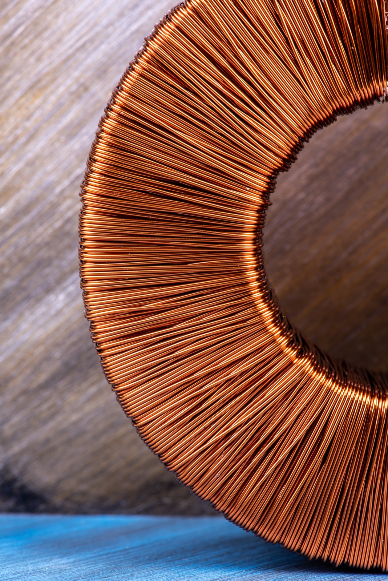 Toroidal inductor close-up showing precision copper winding